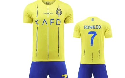 A yellow football kit, shirt and shorts laid out together, with a squad number seven on the shirt