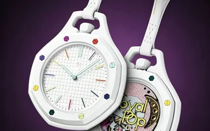 A white-cased watch with a multicoloured dial and matching strap, photographed against purple